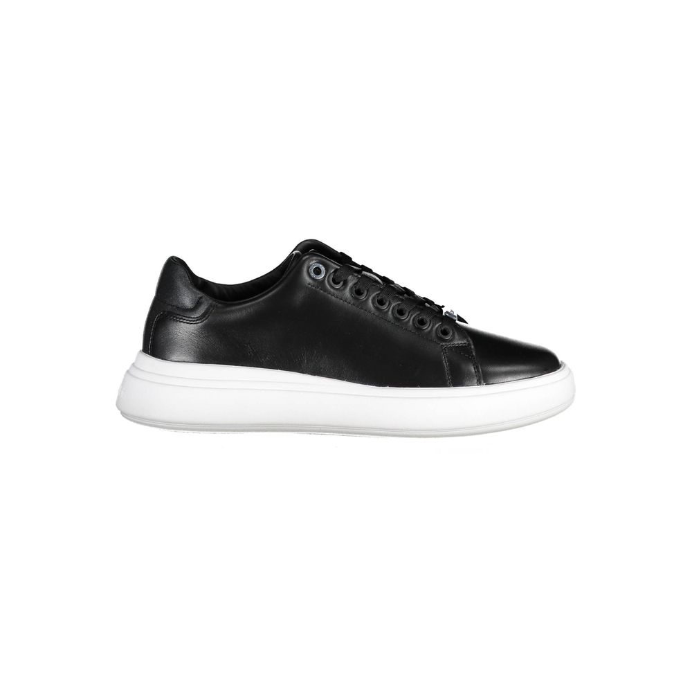 Calvin Klein women’s black leather low-top sneaker with a thick white rubber sole and tonal eyelets.