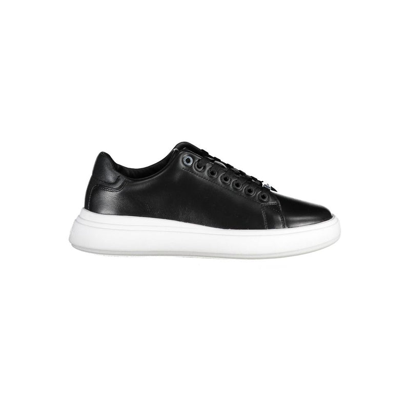 Calvin Klein women’s black leather low-top sneaker with a thick white rubber sole and tonal eyelets.