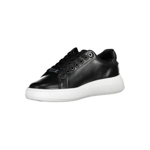 Calvin Klein women's black leather lace-up sneaker with a thick white platform sole and metal logo charm.