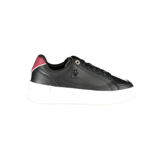 Tommy Hilfiger women’s black leather sneaker with a thick white platform sole and burgundy heel tab accent.