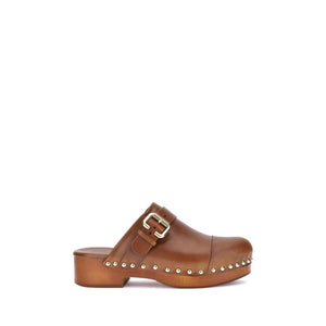 Brown clog shoe with a buckle and studs on a white background