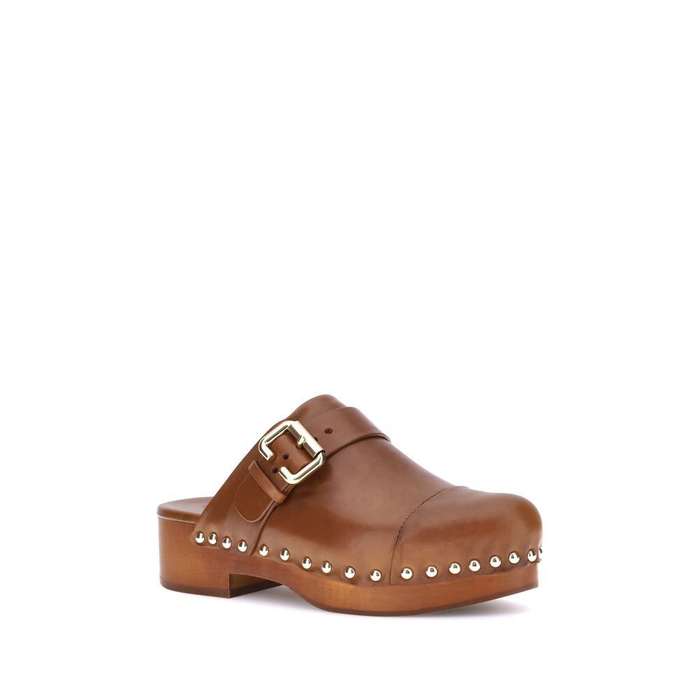 Brown Chloé calf leather clog with a gold-tone buckle strap, wooden platform sole, and silver stud detailing.