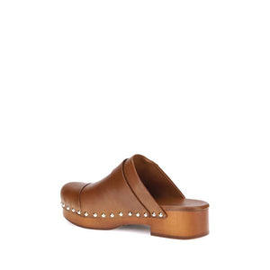Brown leather clog with studded details on a white background