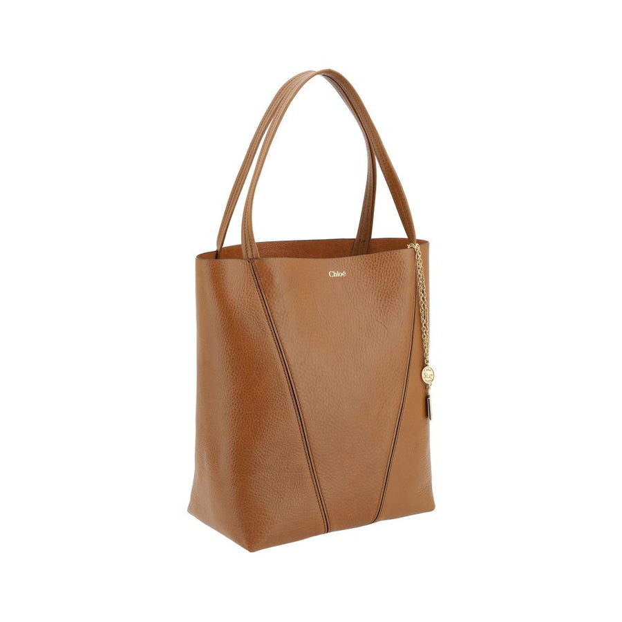 Brown leather Chloé shoulder bag with dual straps and hanging gold chain charm