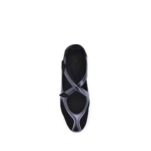 Top-down view of a modern black ballet sneaker with mesh paneling, metallic trim, and a secure strap closure.