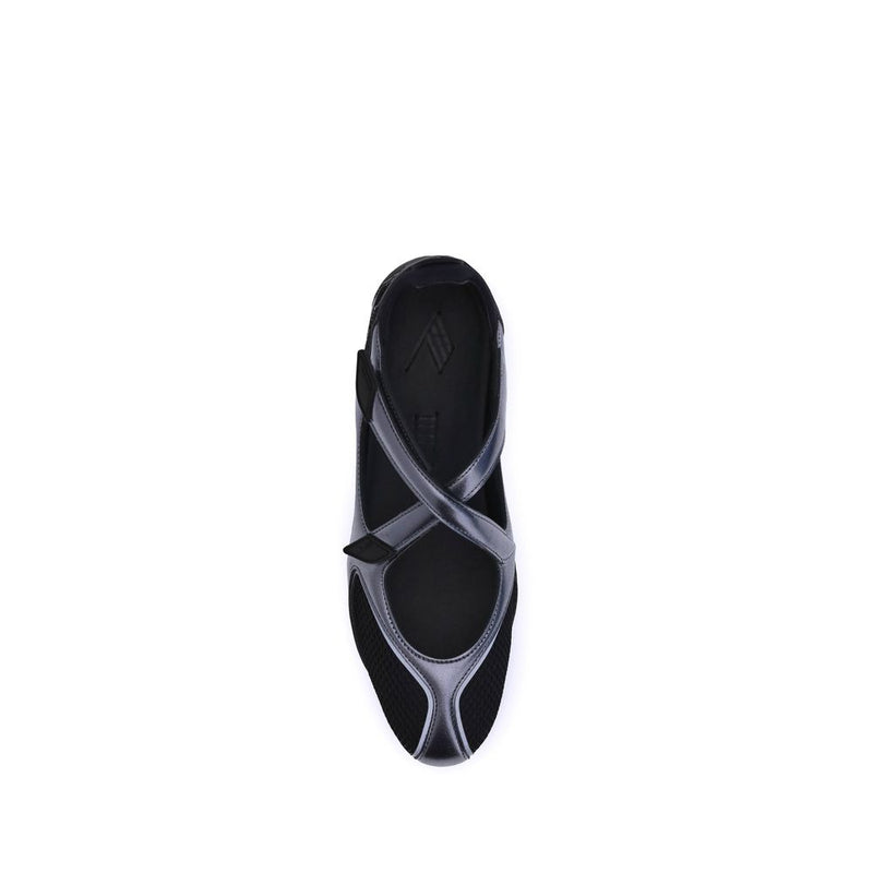 Top-down view of a modern black ballet sneaker with mesh paneling, metallic trim, and a secure strap closure.