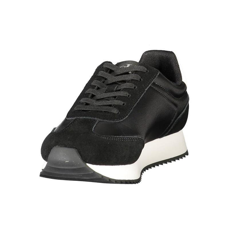 Calvin Klein women's black suede and fabric sneakers with a white platform sole and lace-up design.