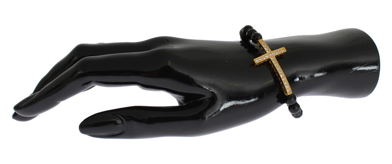 Black beaded stone bracelet featuring a gold cross pendant with cubic zirconia stones on a mannequin hand
