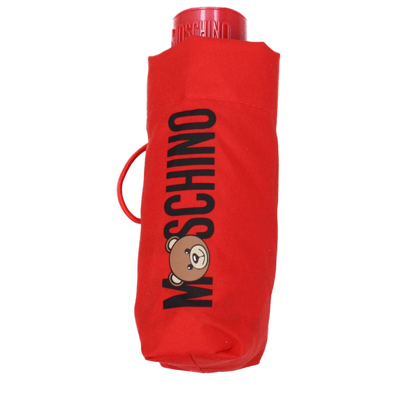 Closed red polyester Moschino umbrella with black logo and teddy bear graphic