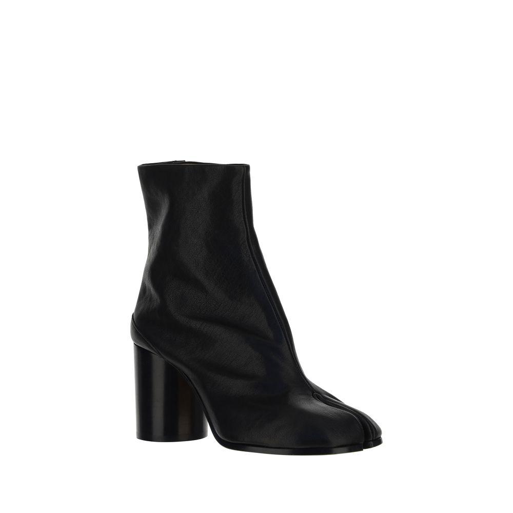 Black ankle boot with a block heel on a white background