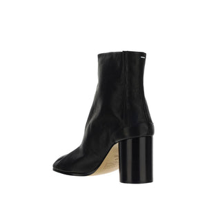 Black ankle boot with a block heel on a white background