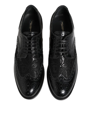 Dolce & Gabbana black leather lace-up formal brogues featuring intricate floral lace panels and perforated detailing.