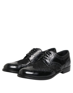 Black leather Dolce & Gabbana lace-up dress shoes with wingtip brogue detailing and floral lace overlay inserts.