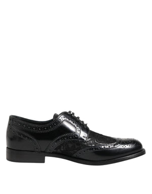 Dolce & Gabbana black leather and lace brogue dress shoe with perforated wingtip detailing and lace-up closure.