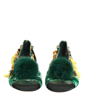 Green high-heeled shoes with fur pom-poms on a white background