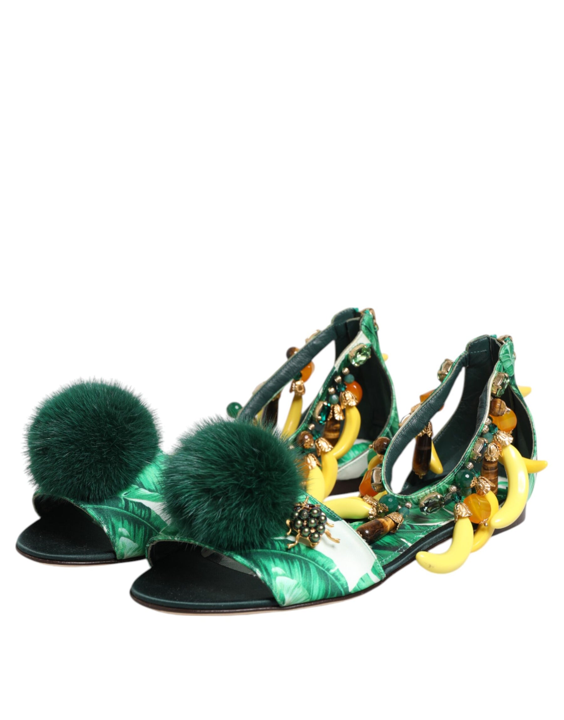 Green sandals with decorative elements on a white background