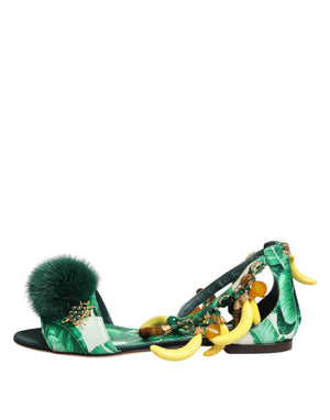 Green sandal with banana design and pom-pom on a white background
