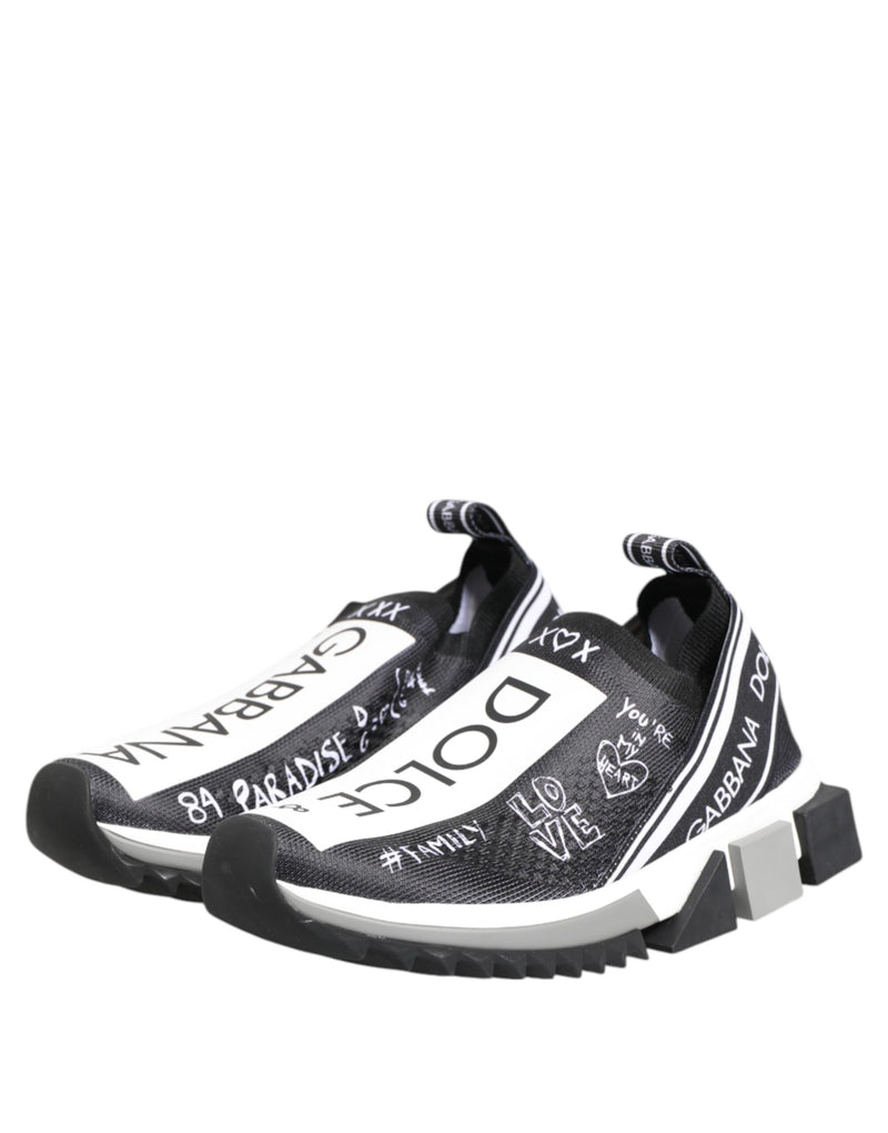 Dolce & Gabbana black and white slip-on sneakers in knit fabric with graphic graffiti-style logo text and chunky soles.