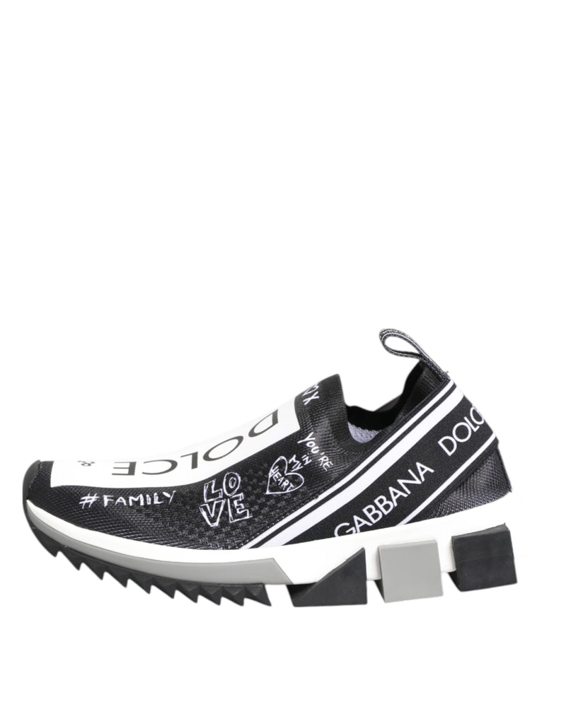 Dolce & Gabbana black and white stretch-knit low-top sneakers with graffiti-style branding and chunky lug sole.