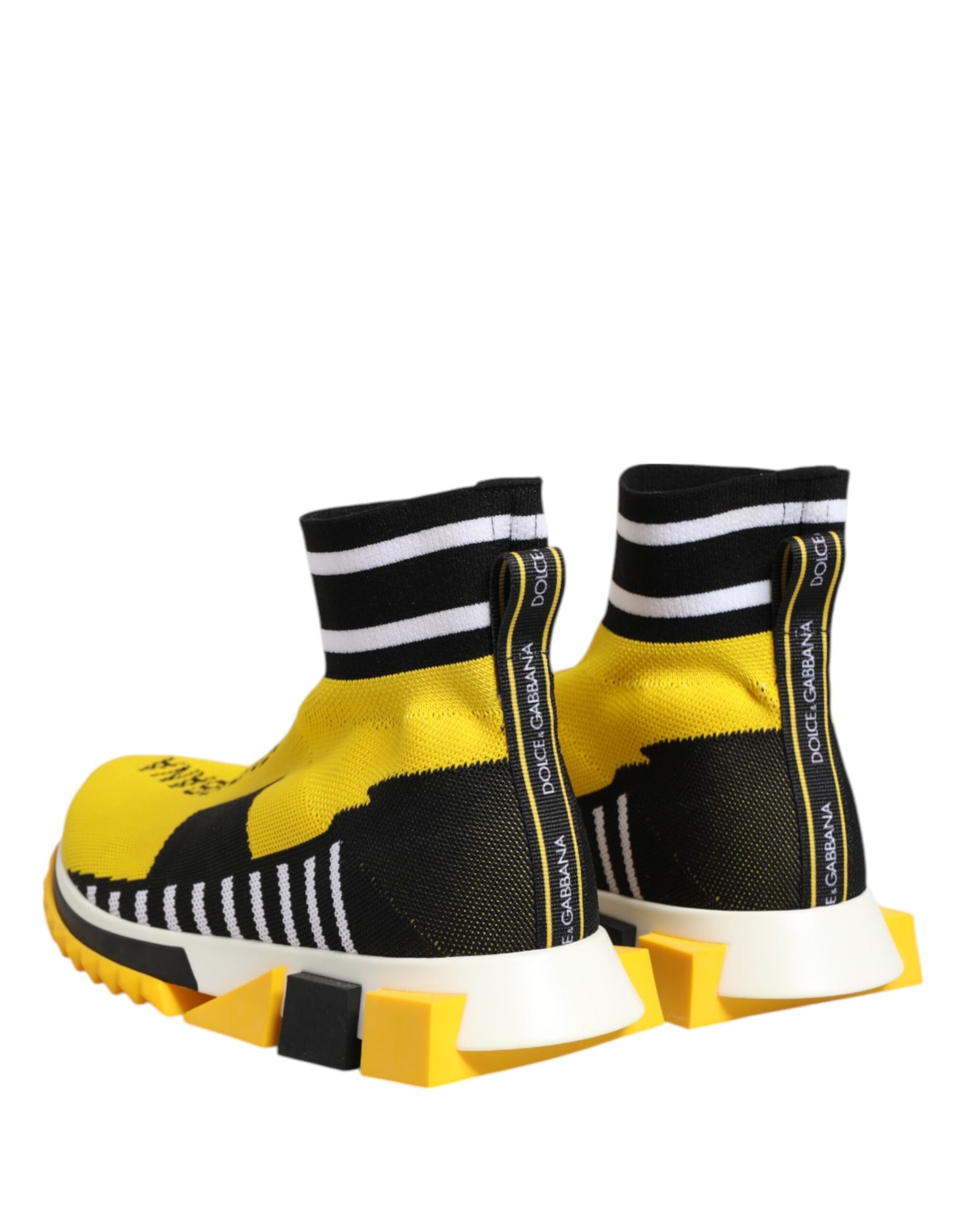 Dolce & Gabbana yellow and black knit sock sneakers with white striped cuffs, logo pulls, and chunky geometric soles.