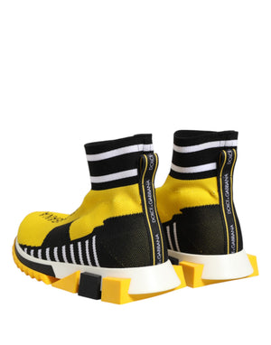 Dolce & Gabbana yellow and black knit sock sneakers with white striped cuffs, logo pulls, and chunky geometric soles.