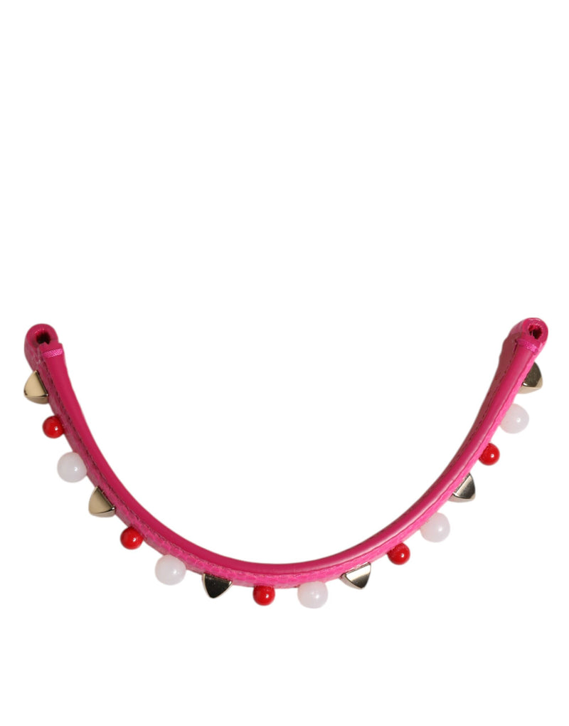 Pink leather handbag handle embellished with red beads and metallic studs