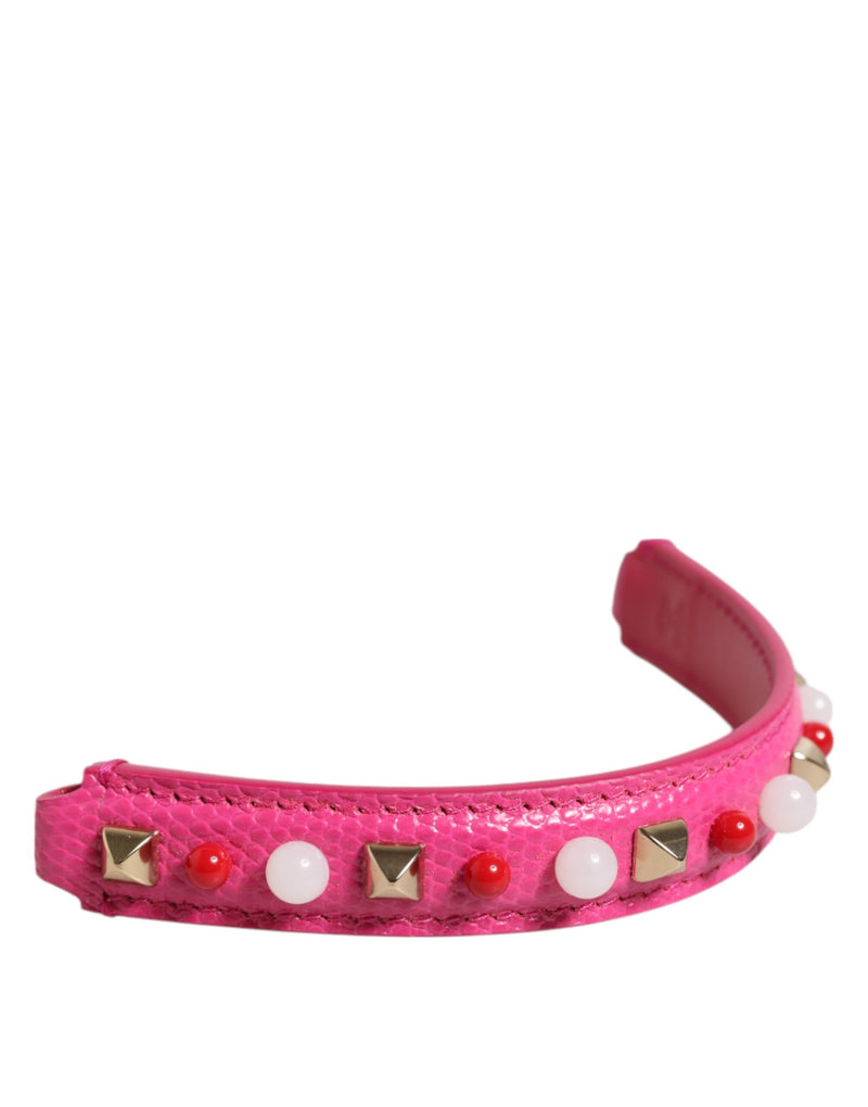 Pink textured leather bag handle adorned with studs and beads