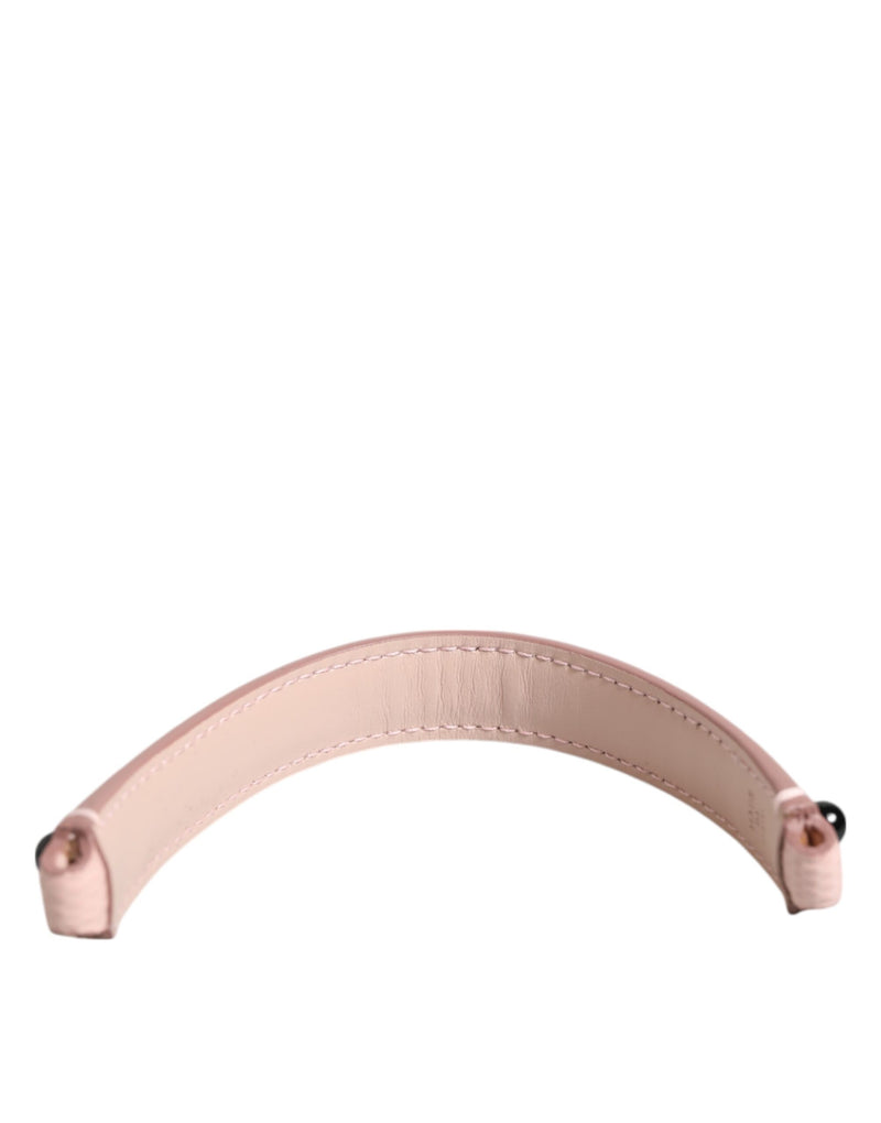 Light pink leather bag handle with stitched edges and hardware ends