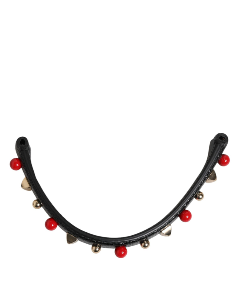 Black leather curved bag handle embellished with red beads and gold studs