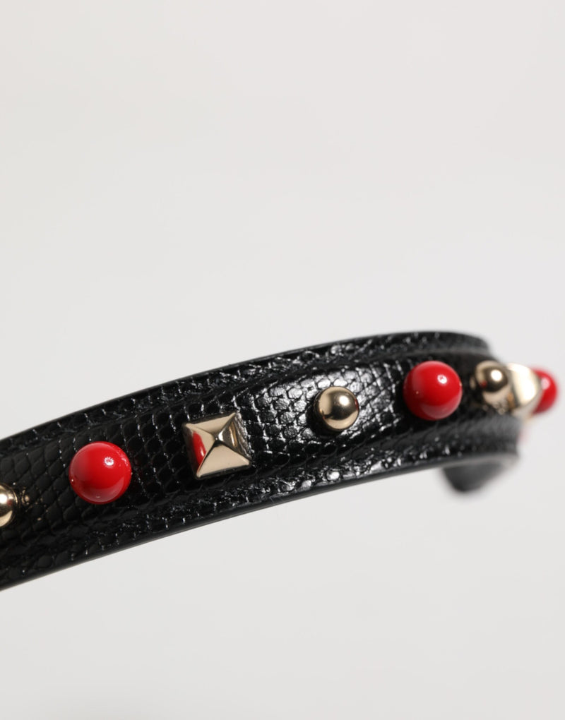 Black textured leather bag handle with red beads and gold studs
