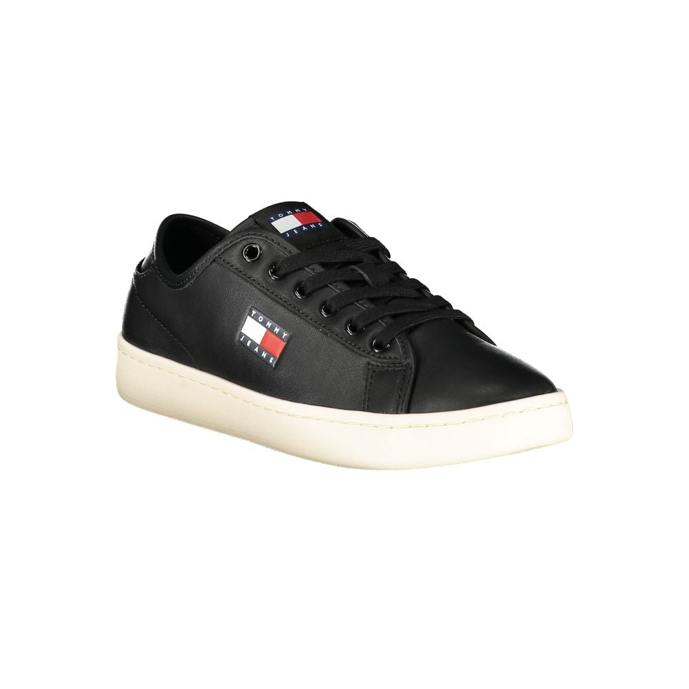 Tommy Hilfiger black polyurethane women's lace-up sneaker with logo patch and contrast white rubber sole.