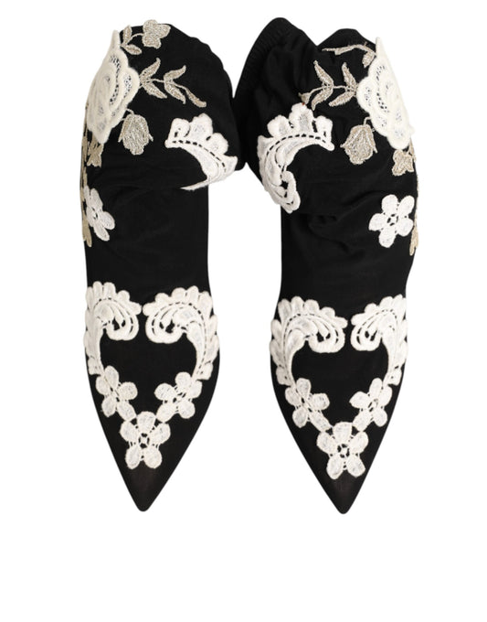 Black pointed-toe ankle boots in soft material with intricate white and metallic floral lace embroidery.