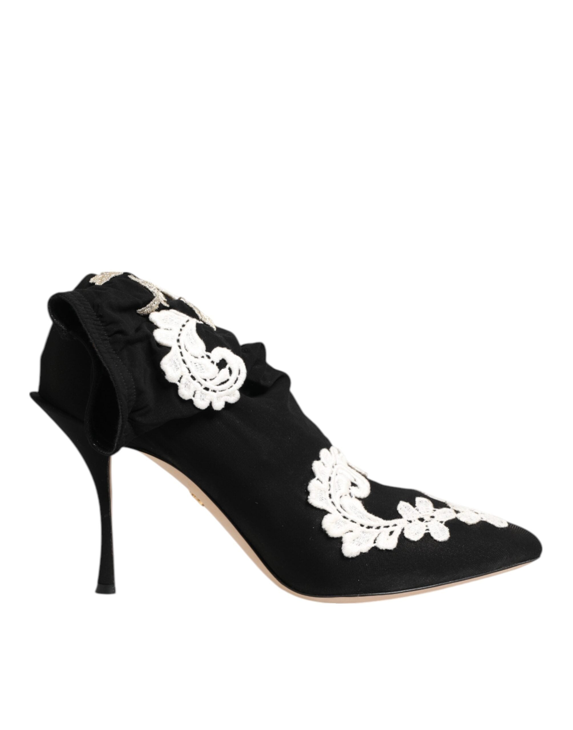 Black satin stiletto pump with ruffled ankle detail and intricate white lace appliqué.