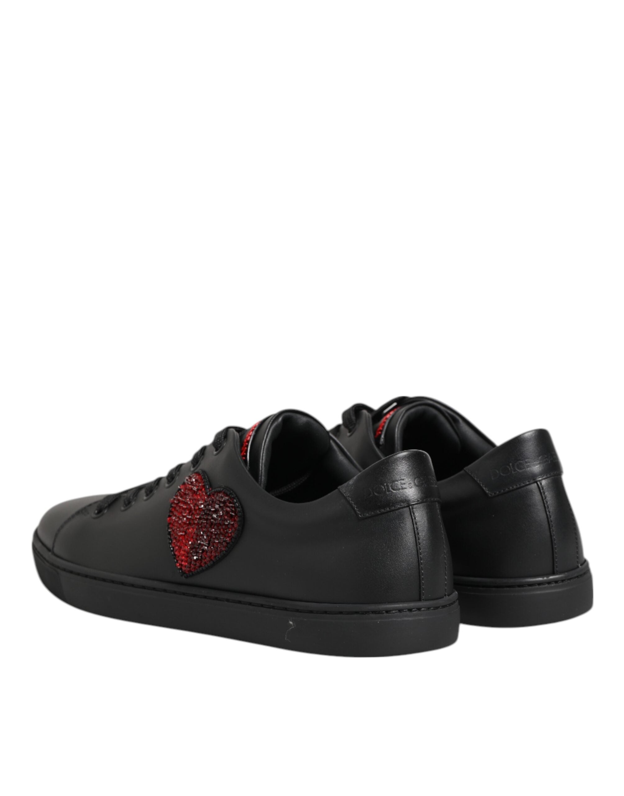 Black leather low-top sneakers with a red crystal-embellished heart detail and Dolce & Gabbana branding.