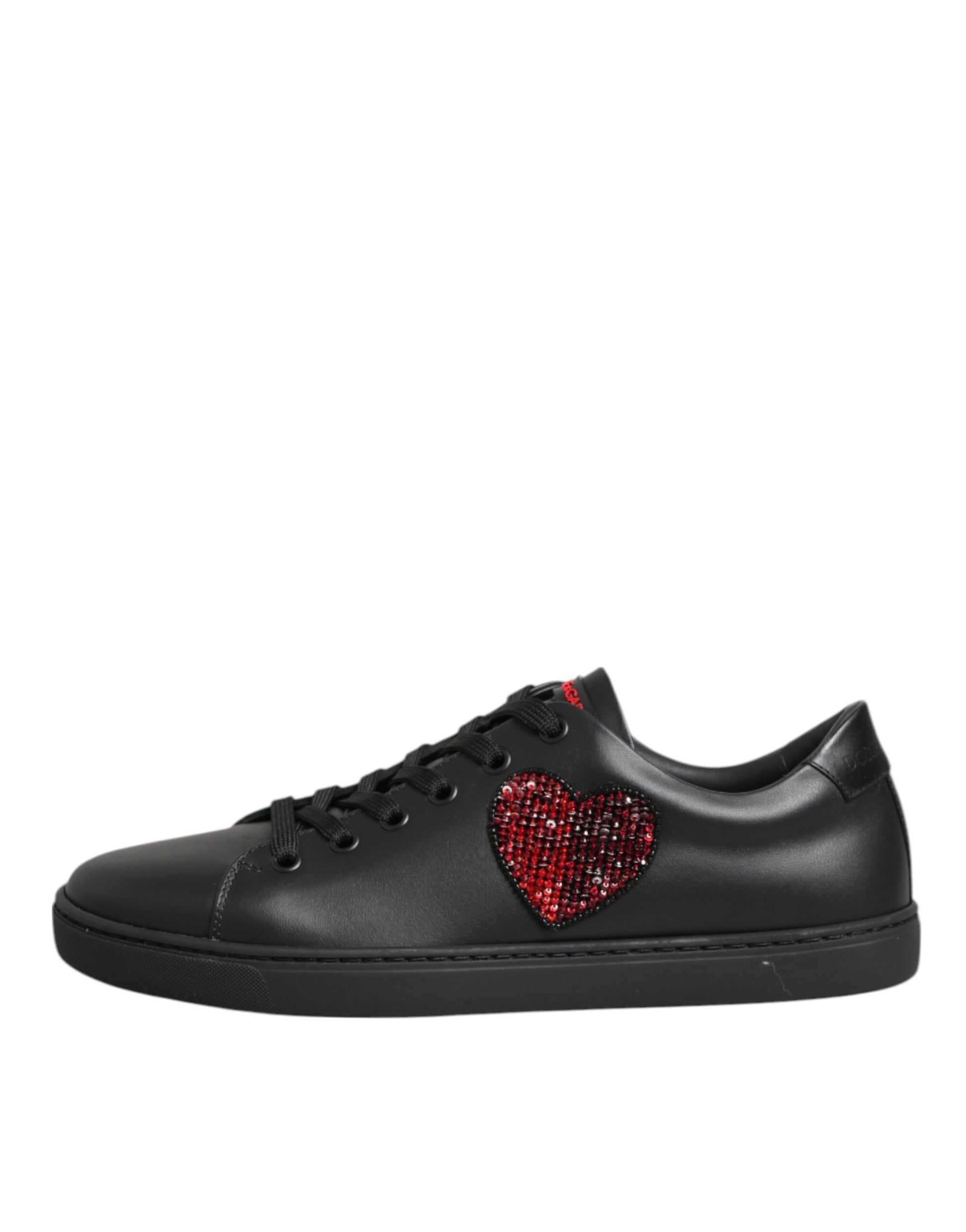 Black leather Dolce & Gabbana low-top sneakers featuring a red crystal-embellished heart appliqué on the side.
