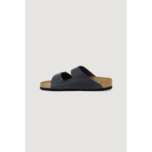 Side view of a black leather double-strap sandal with a molded cork footbed and black rubber outsole.