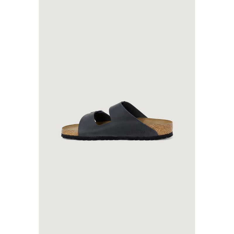 Side view of a black leather double-strap sandal with a molded cork footbed and black rubber outsole.