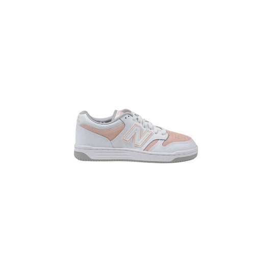 New Balance low-top sneaker in white and soft pink leather with a signature "N" logo and grey rubber sole.