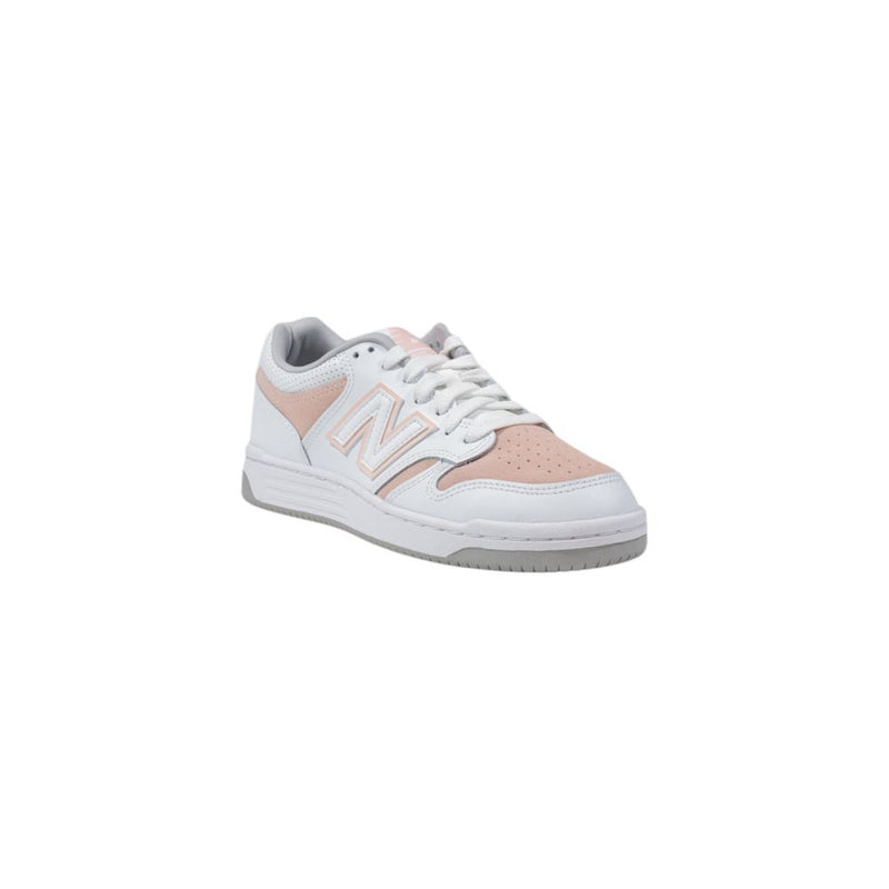 New Balance lifestyle sneakers featuring a white leather upper, pink perforated toe and side panels, and grey accents.
