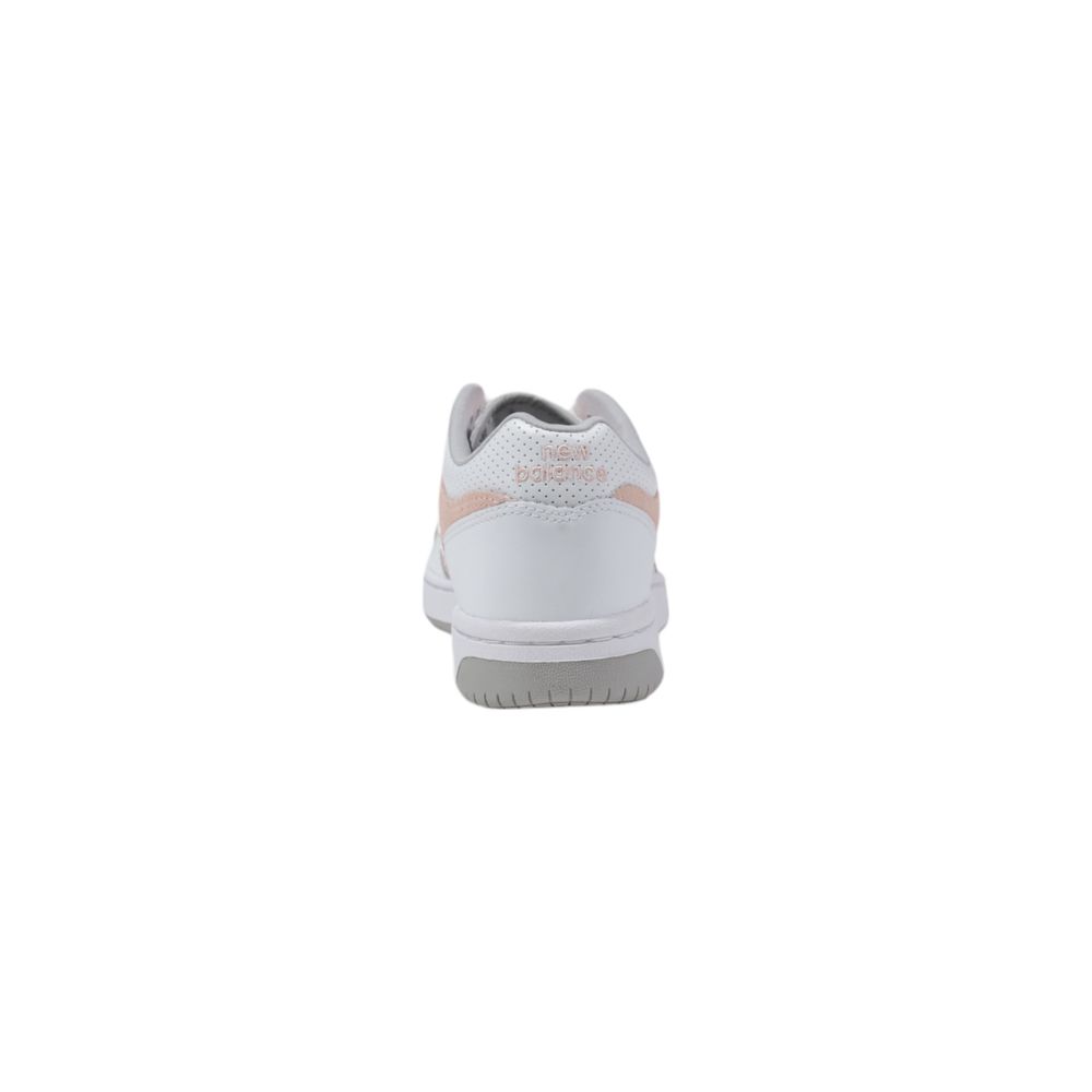 Back view of New Balance white leather sneakers with pale pink accents and a grey sole.
