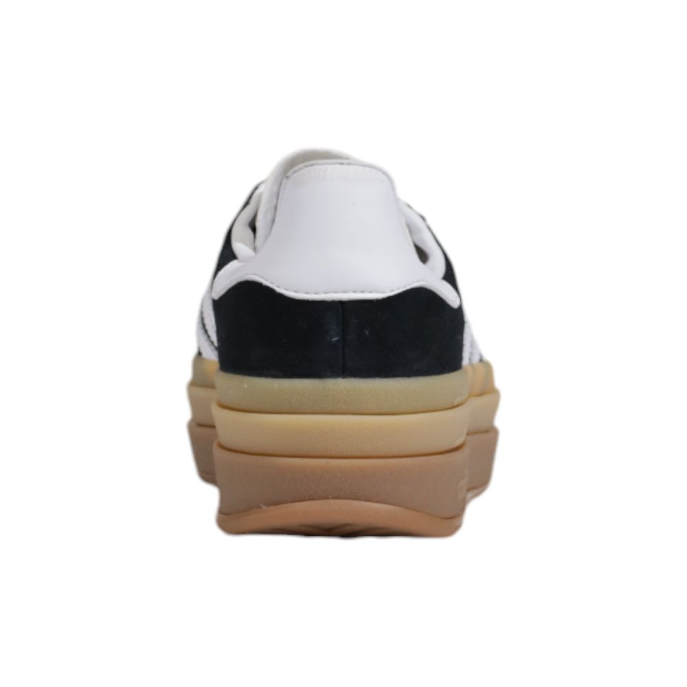 Adidas Originals low-top sneaker in black suede with a white leather heel tab and a layered beige platform sole.