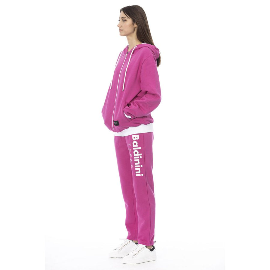 Woman wearing magenta cotton zip-up hoodie and matching sweatpants with white trim