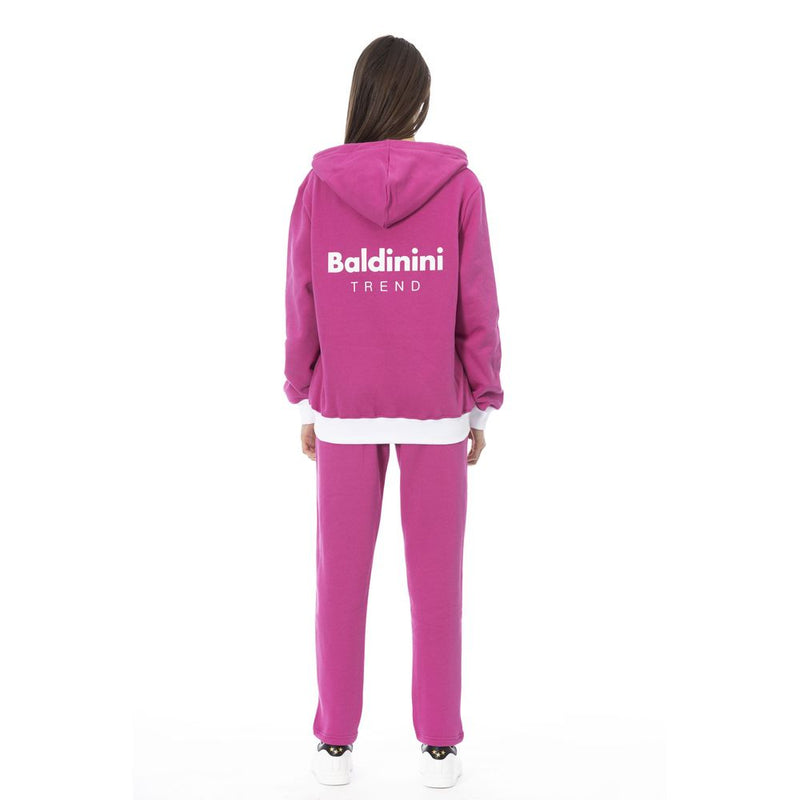 Magenta cotton hooded sweater with white brand logo on the back worn by a woman