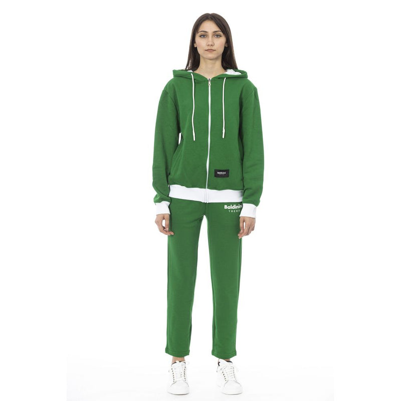 Woman wearing a green cotton zip-up hoodie and matching sweatpants set with white accents