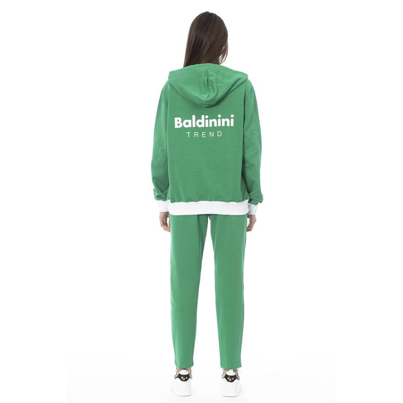 Green cotton hooded sweatshirt with white logo on the back worn with matching sweatpants