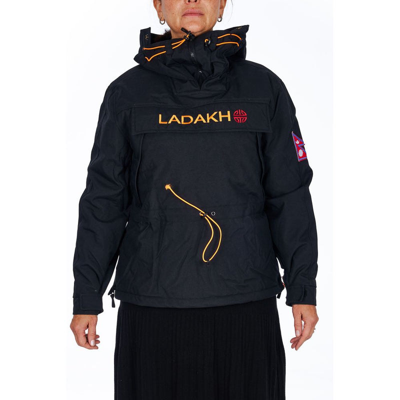 Black polyester women's anorak jacket with a hood, orange drawstrings, and Ladakh branding