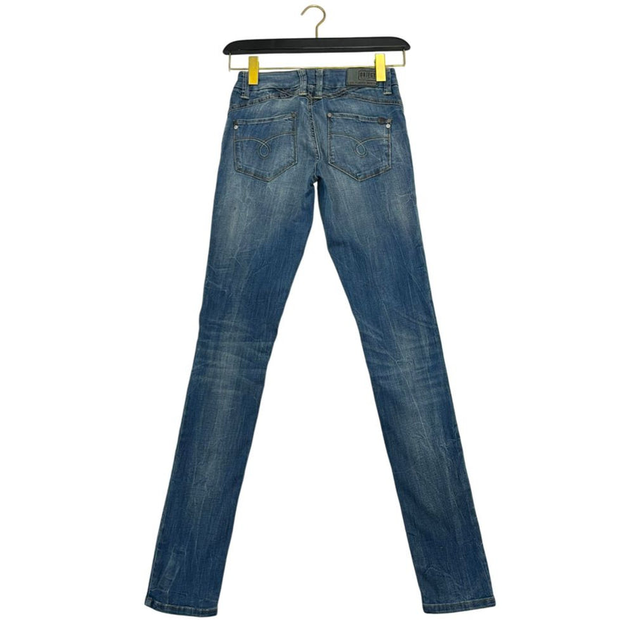 Blue cotton women's skinny jeans hanging on a hanger