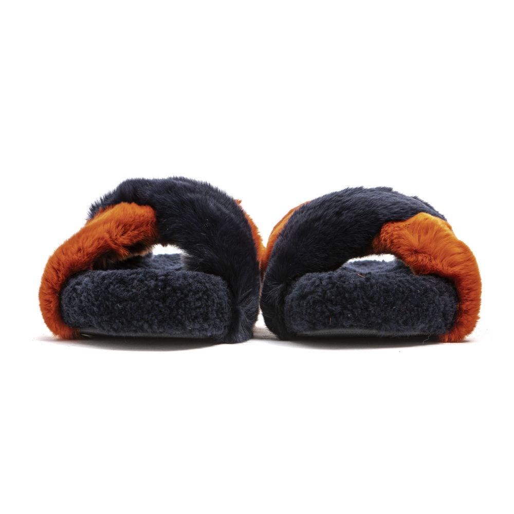 Mr&Mrs Italy slides featuring navy and orange rabbit fur with a crisscross strap design and fluffy footbeds.
