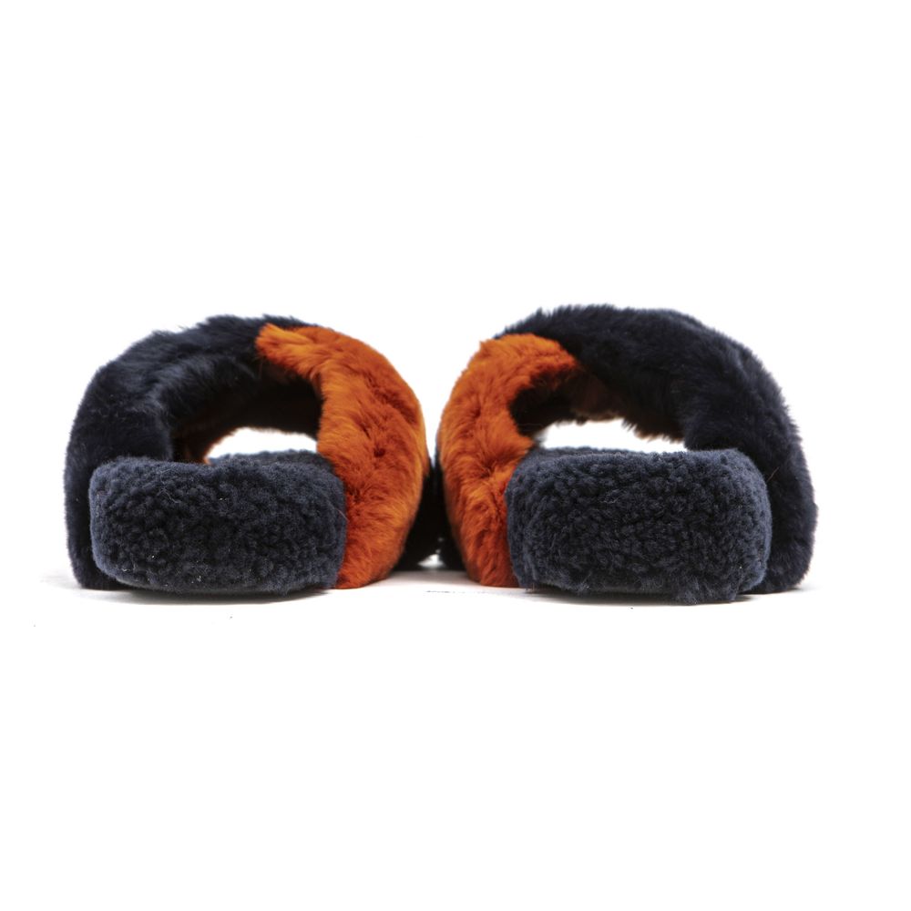 Women’s slip-on sandals featuring overlapping navy blue and rust-orange rabbit fur straps on a matching fur footbed.