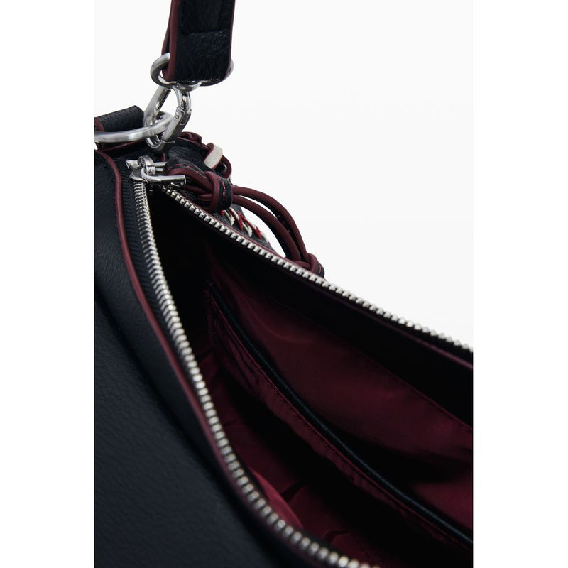 Black polyurethane women's handbag interior with a burgundy lining and zipper closure